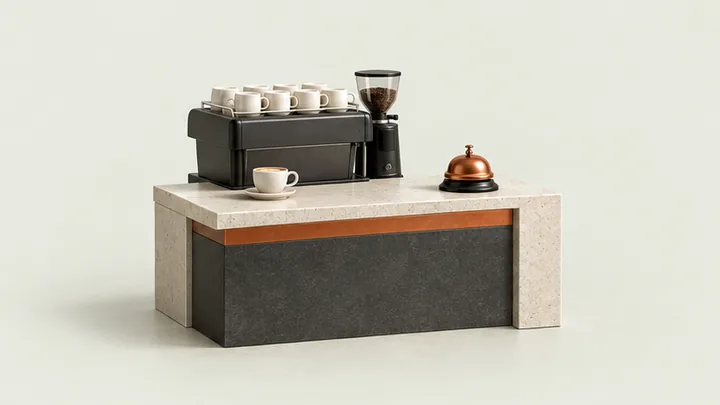 Miniature cafe counter, espresso machine, and reception bell representing hospitality.